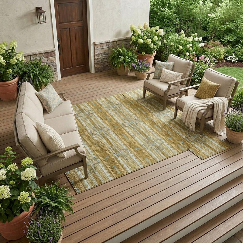 Rectangular area rug with tan and blue tribal geometric design on outdoor patio floor