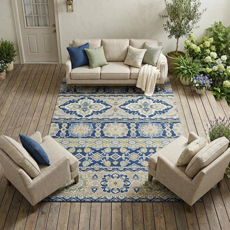 Navy and beige tribal area rug laid on wood floor under seating with patterned center stripes
