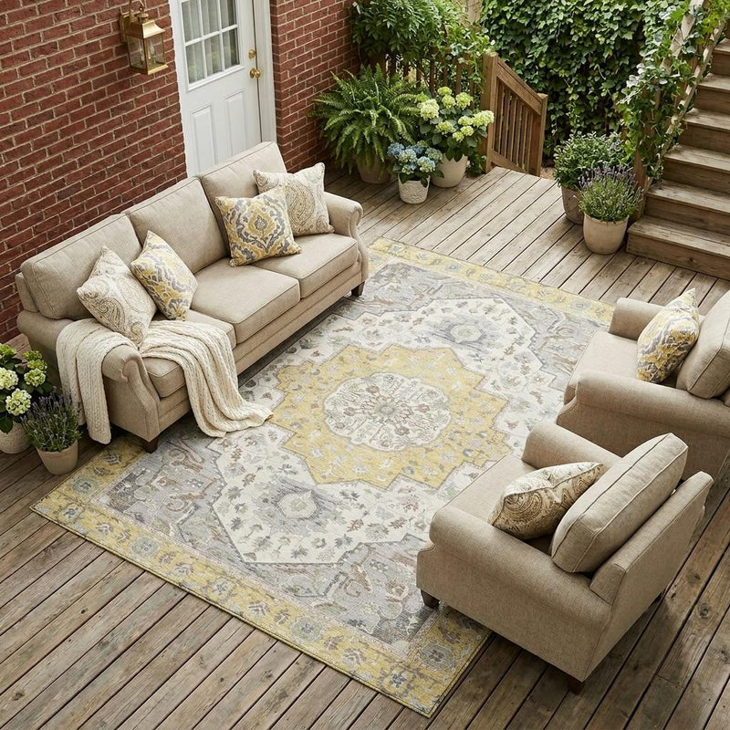 Indoor outdoor area rug with cream, gray, and yellow ornamental medallion pattern