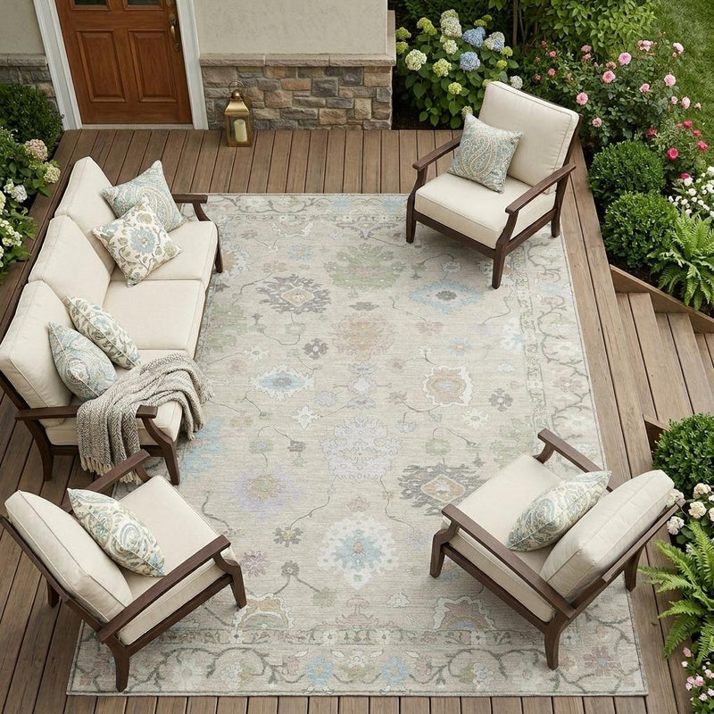 Outdoor patio area rug with distressed medallion and floral pattern in light green tones