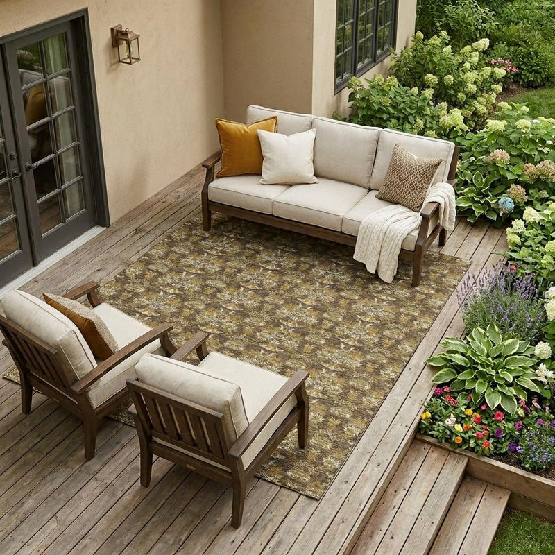 Outdoor floral area rug with repeating damask motifs on a wooden deck
