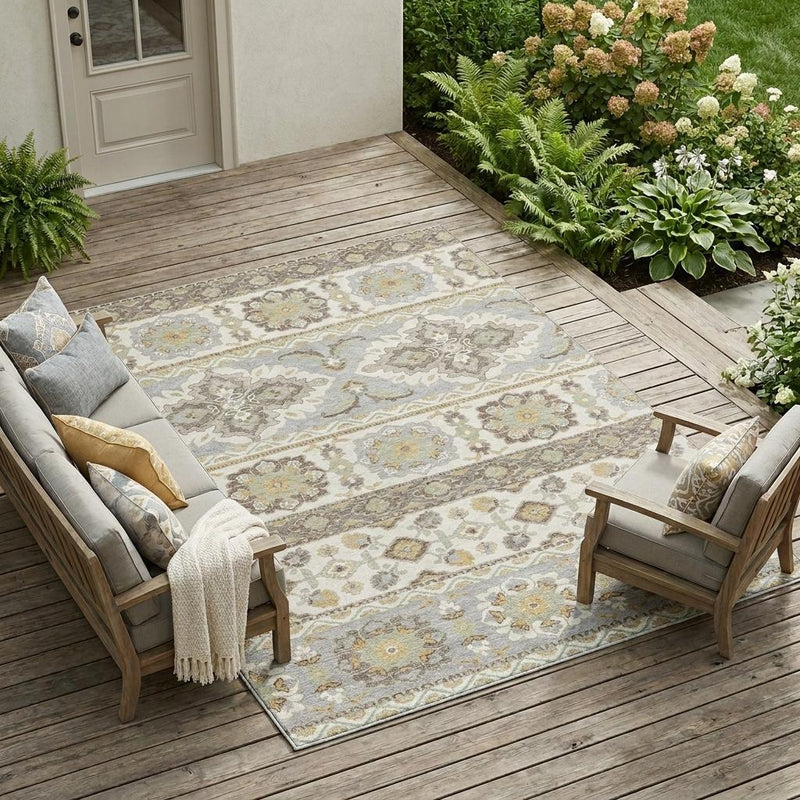 Ivory and silver tribal area rug displayed on an outdoor wooden deck