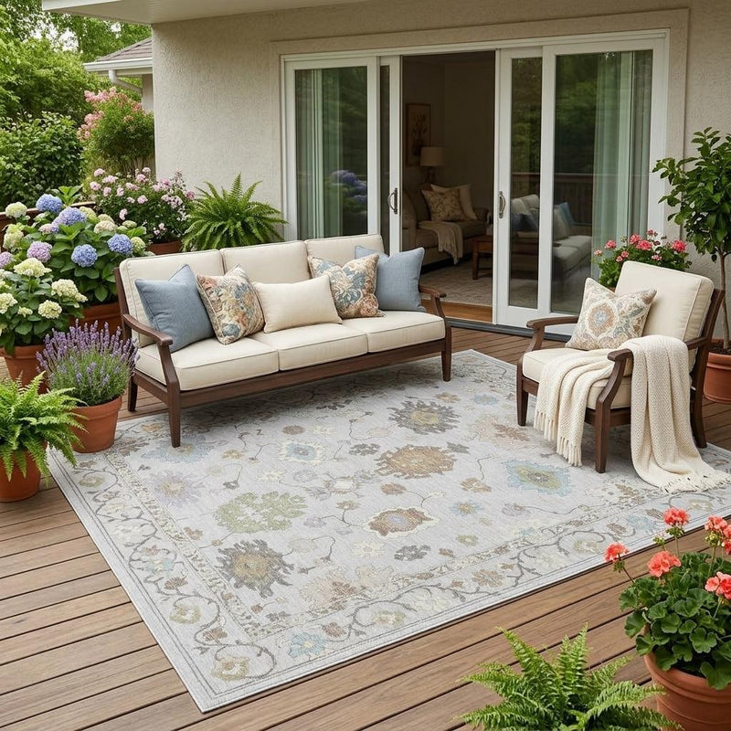 Outdoor area rug with light background and multicolor oriental pattern, neatly edged border