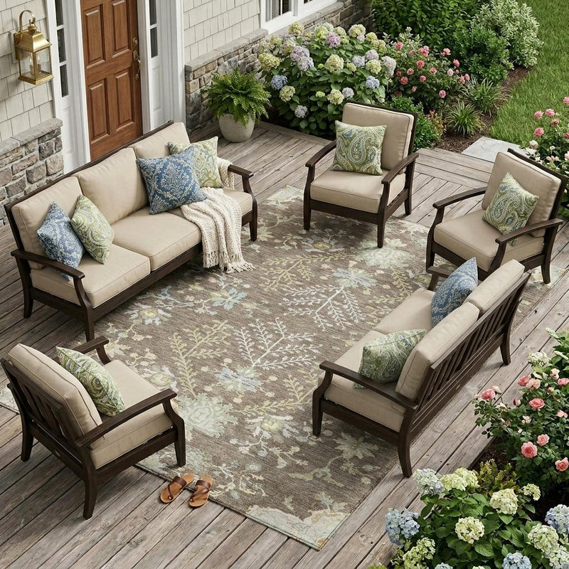Taupe oriental-style area rug with ivory floral motifs on outdoor patio
