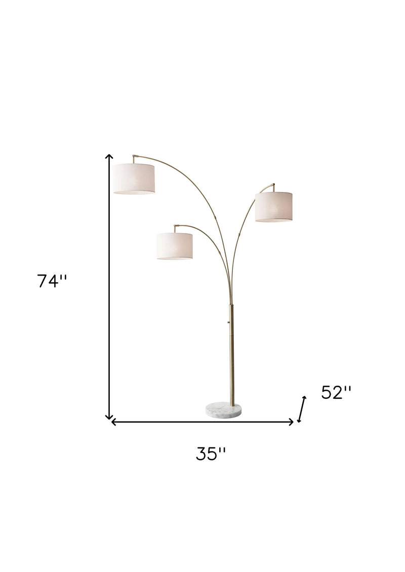 74" Brass Three Light Arc Floor Lamp With Off White Fabric Drum Shade - Lighting