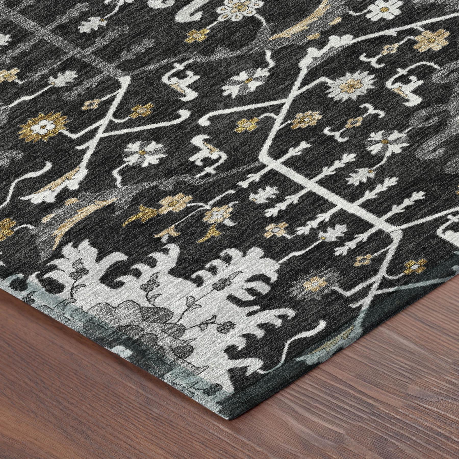 Black and gray area rug with floral patterns in white and gold, offering a modern, stylish accent for home decor.