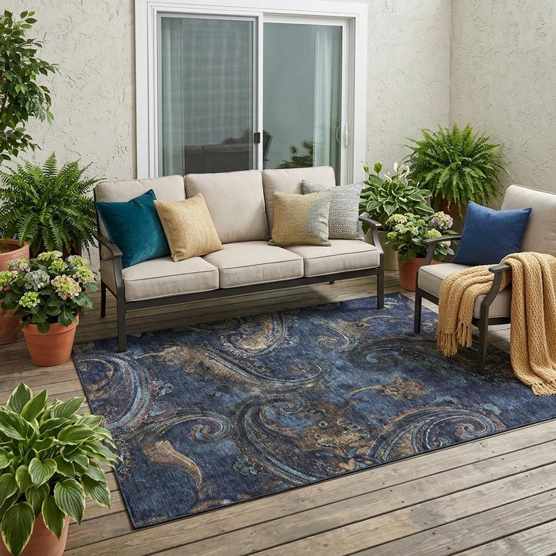 Navy blue paisley area rug with scroll medallion pattern on outdoor patio