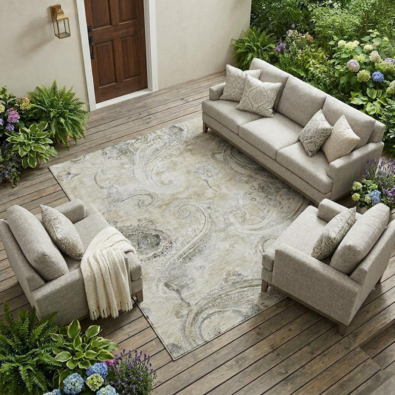 Khaki paisley area rug on outdoor deck, ornate swirl pattern in dark gray