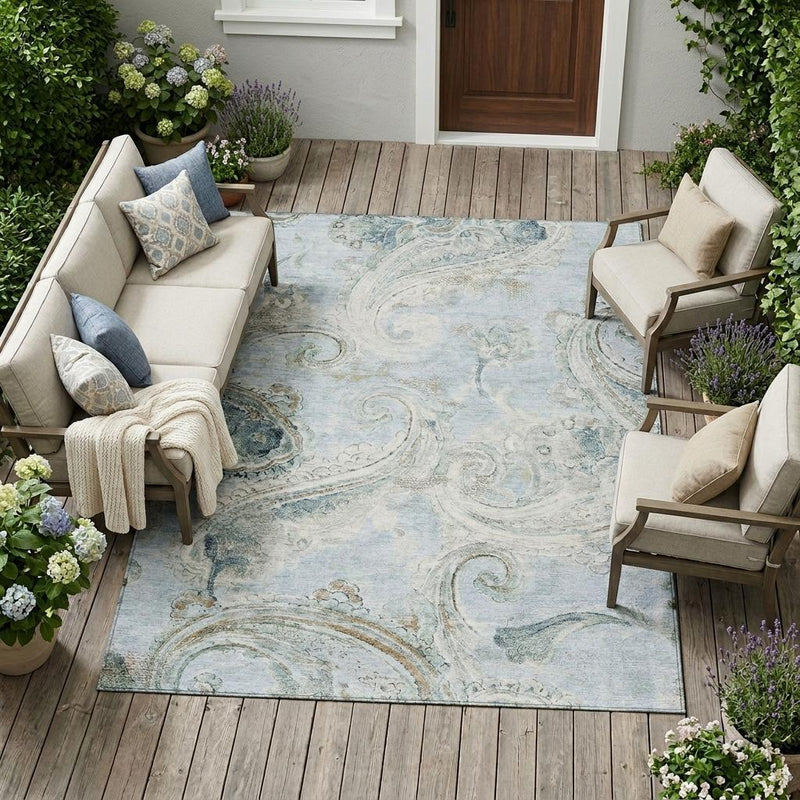 Light blue paisley area rug in an outdoor seating space, distressed cream and blue swirls
