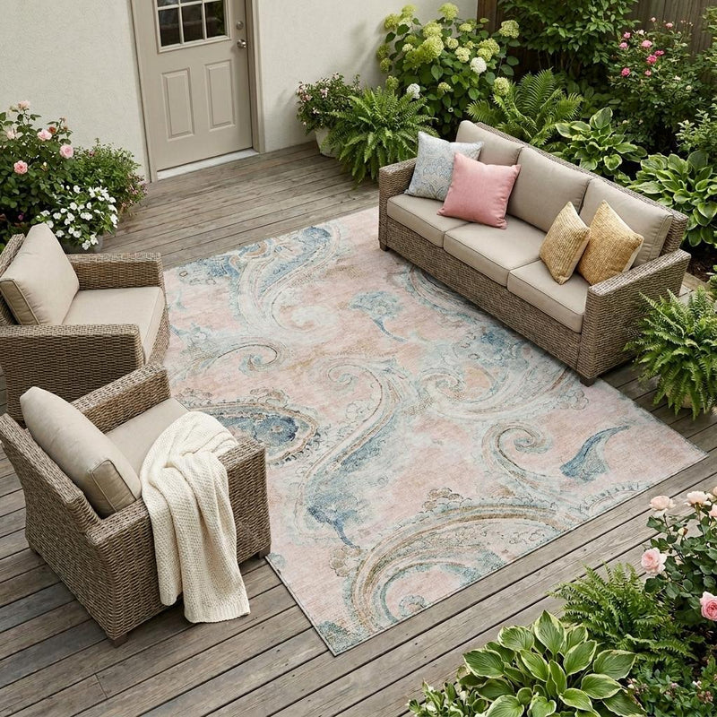 Indoor outdoor area rug on patio with pink and light blue paisley pattern