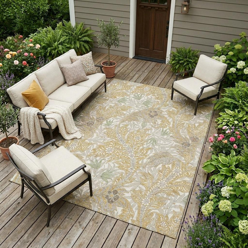 Washable area rug with botanical leaf motif in gold and silver tones