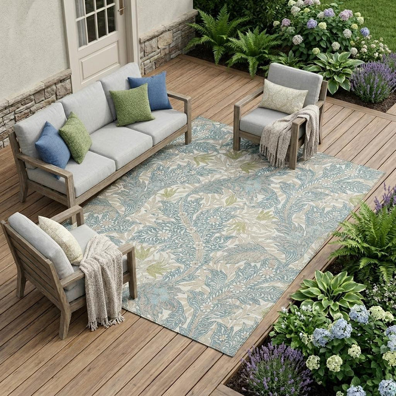 Teal botanical area rug with cream and green leaf pattern for indoor outdoor use