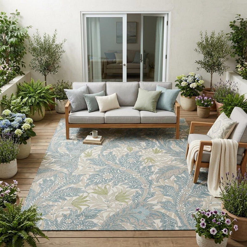 Teal blue botanical leaf area rug with scrollwork and soft ivory background