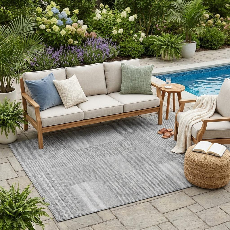Gray striped outdoor area rug with textured weave and subtle geometric motifs
