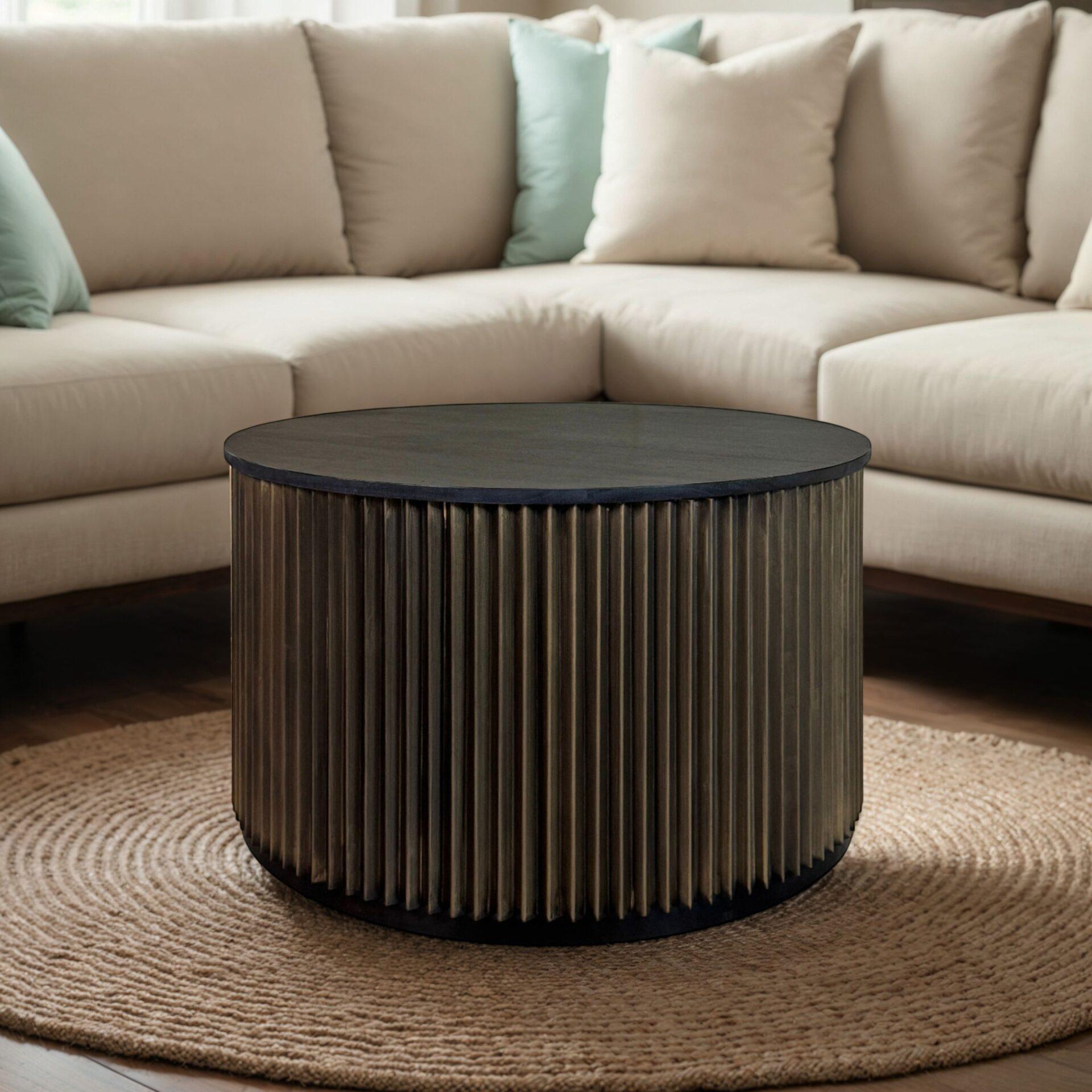Round drum coffee table front view: black top with ribbed brass-toned sides