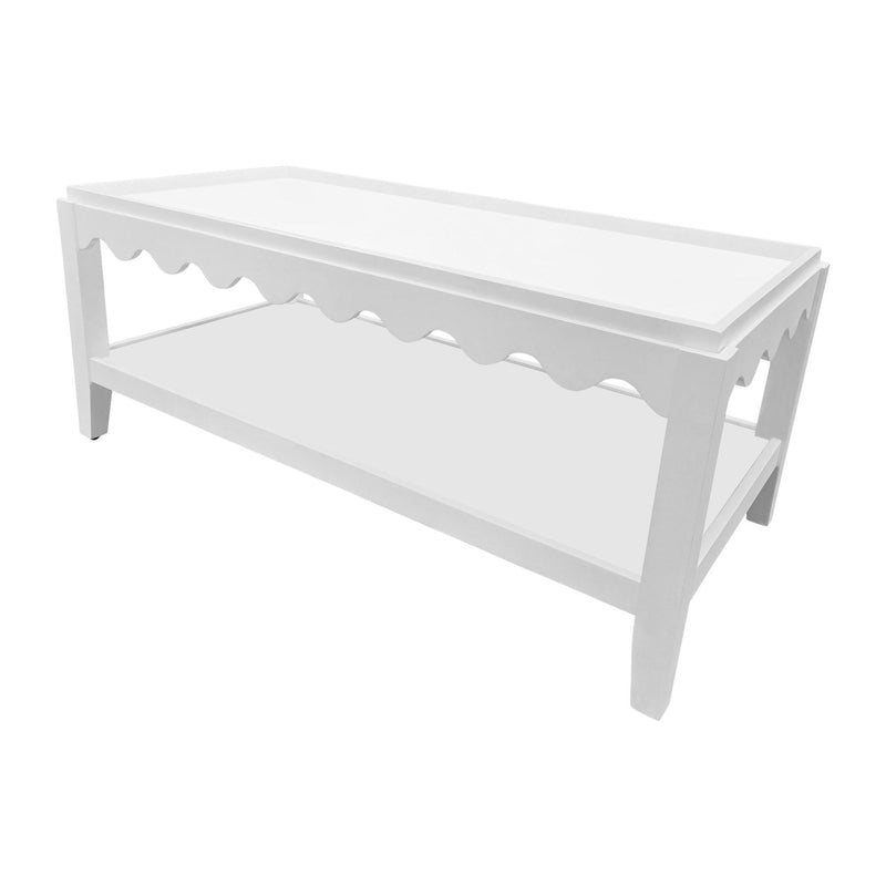 White solid wood coffee table with scalloped underside apron and open lower shelf
