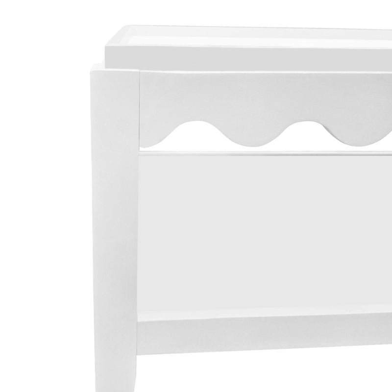 White solid wood coffee table corner detail with scalloped front panel and open shelf