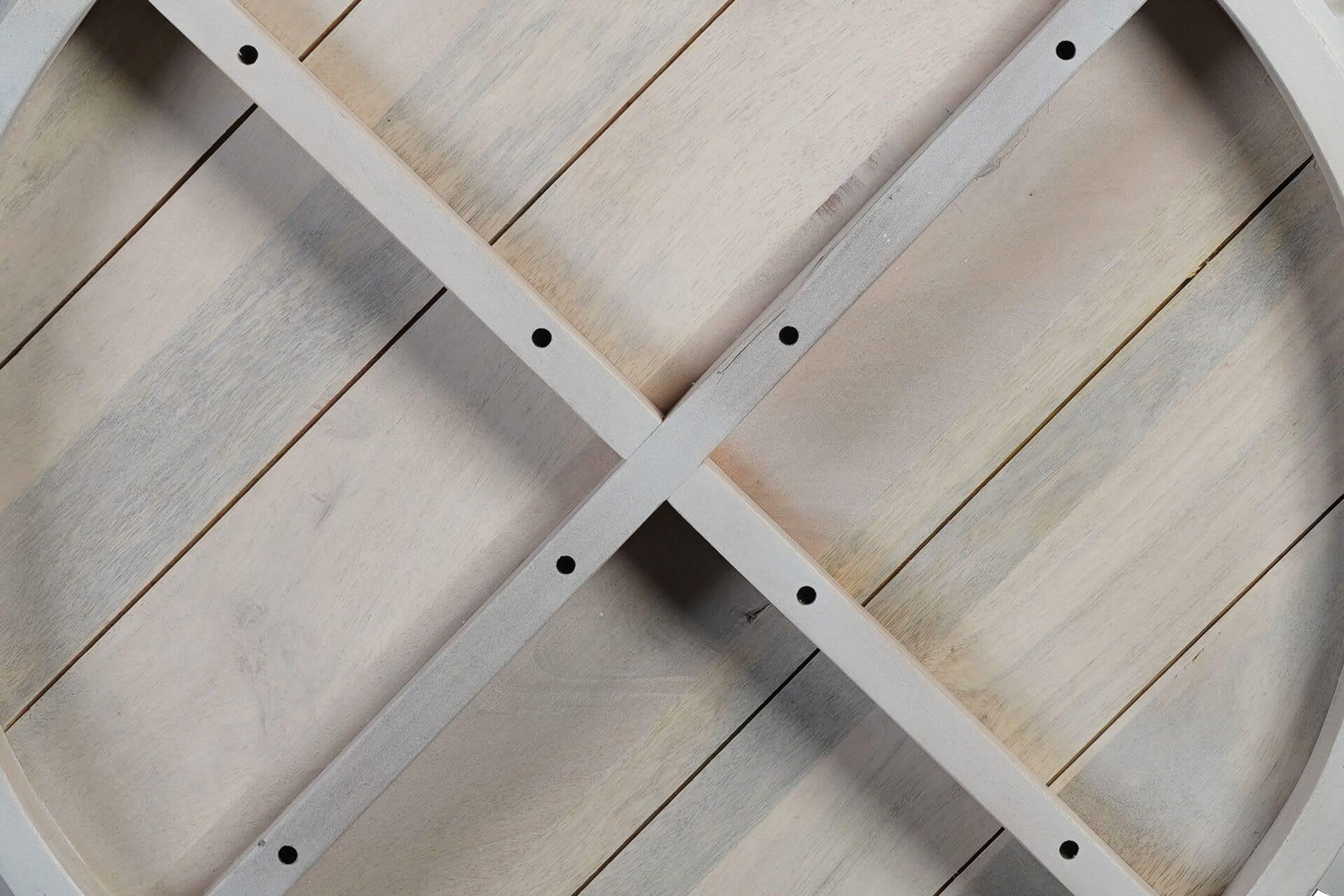 White round wood coffee table underside with crisscross braces and bolt holes