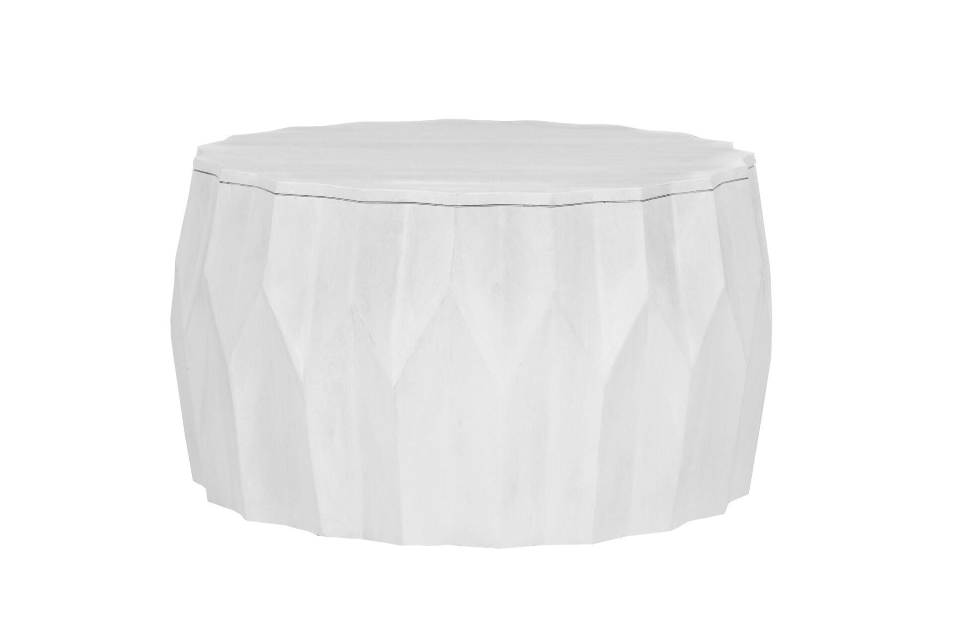 White round drum coffee table with faceted distressed body and flat top surface
