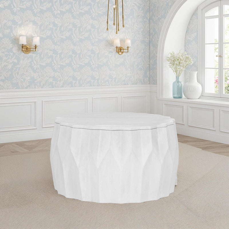 White round drum coffee table with faceted sides and textured finish