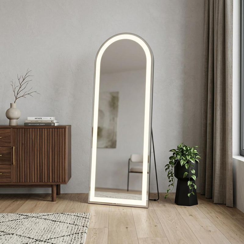 Standing full-length arched mirror with warm LED-lit silver frame