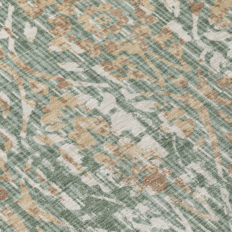 Close-up of green and sage damask rug texture with geometric vine-style ornamentation.