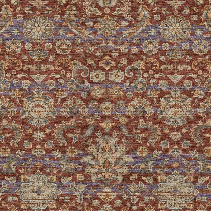 Close-up floral medallion pattern on multicolor area rug in burgundy and blue