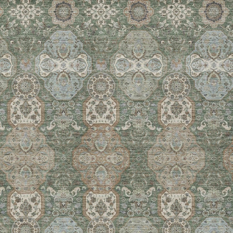 Close-up of green and silver floral geometric indoor outdoor area rug with repeating medallions