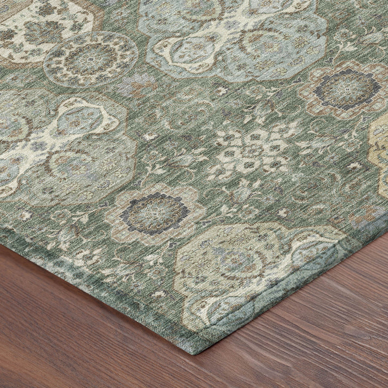 Corner view of green and silver ornate floral geometric indoor outdoor area rug