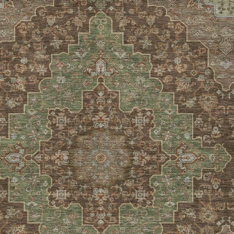 Close-up of brown and olive medallion rug with teal-green inner border
