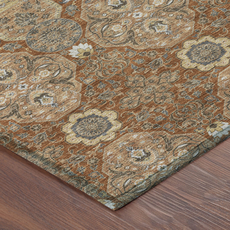 Corner of orange and copper floral area rug showing detailed medallion pattern