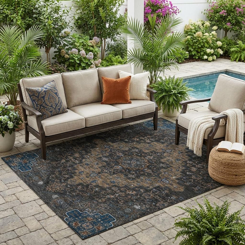 Patio-ready medallion area rug with dark blue, black, and tan ornamental border