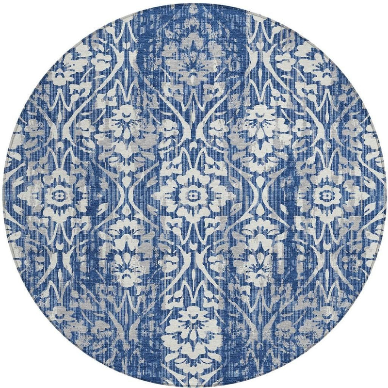 Round blue-and-white damask rug with distressed pattern effect