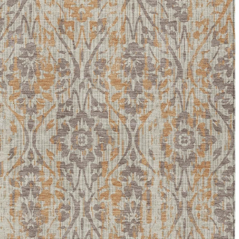 Beige and copper damask area rug close-up with ornate vine pattern and muted gray