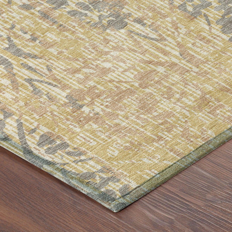 Corner of gold and gray damask area rug with braided border detail