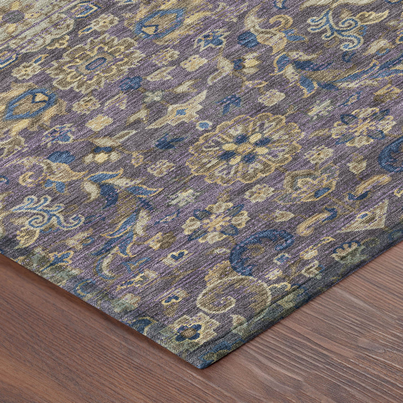 Close-up of purple and blue floral medallion area rug with textured distressed look.