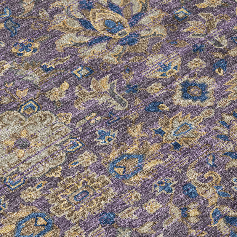 High-detail section of purple floral and geometric medallion area rug in blue tones.