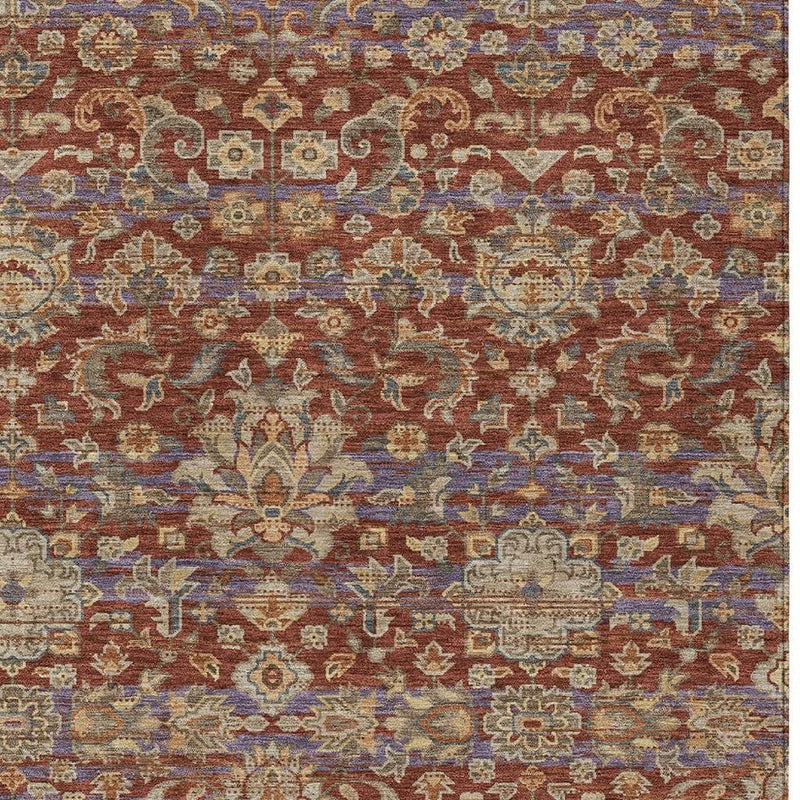 Close-up rug texture with ornate geometric and floral pattern in rust, blue, and beige