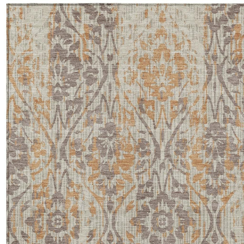 Beige damask area rug with gray and copper ornamental design and border