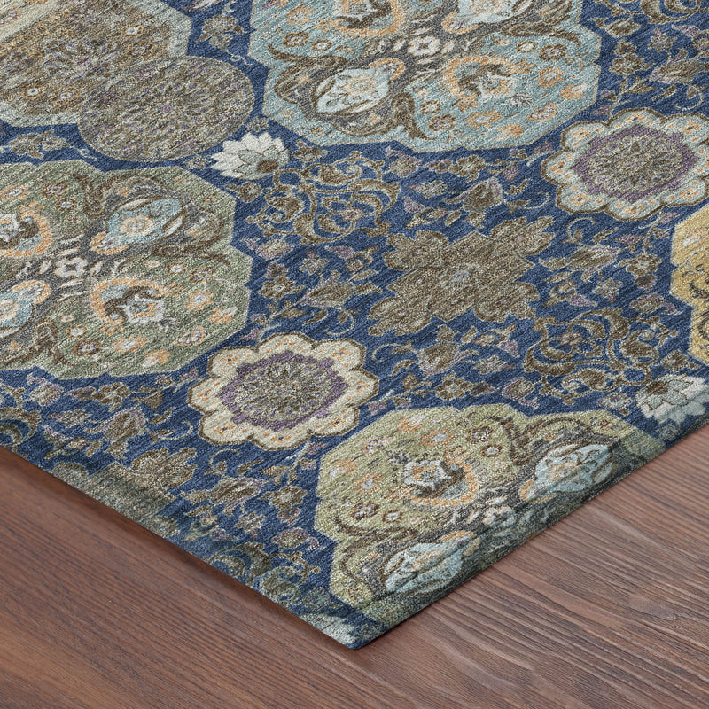 Navy and gray floral area rug showing corner edge and pile texture