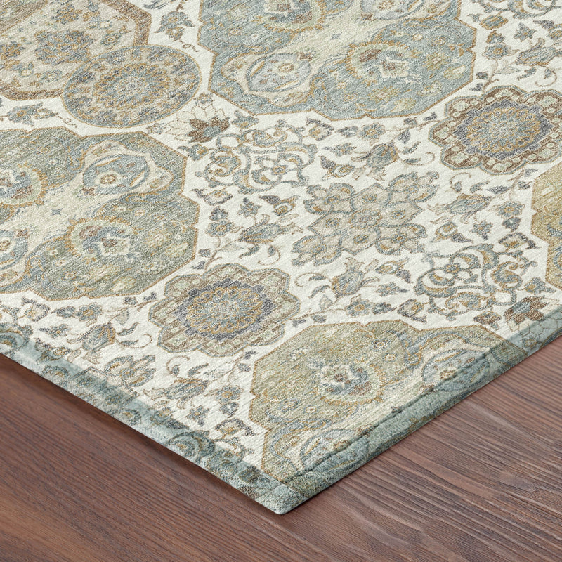 Corner of ivory and blue-gray rug with distressed medallion pattern and bound edge