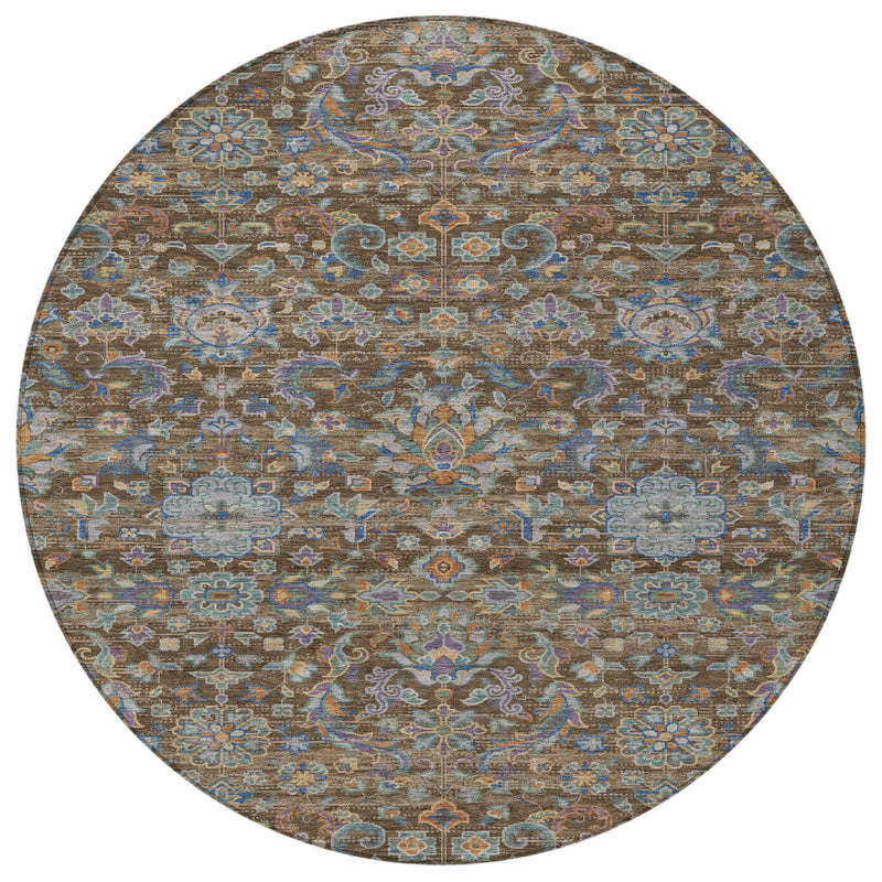 Round area rug with ornate floral medallion pattern in brown, blue, and tan