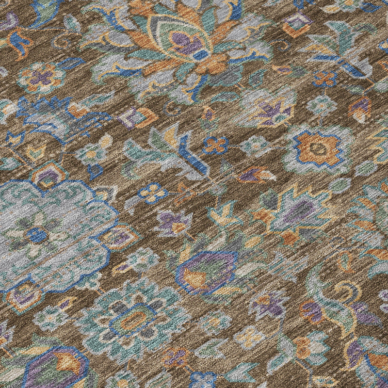 Close-up of round rug texture with multicolor floral motifs in brown and blue
