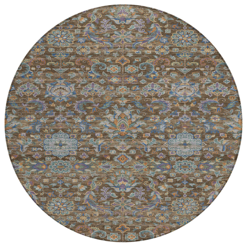 Round area rug with repeating medallion motifs and floral scrollwork in brown and blue