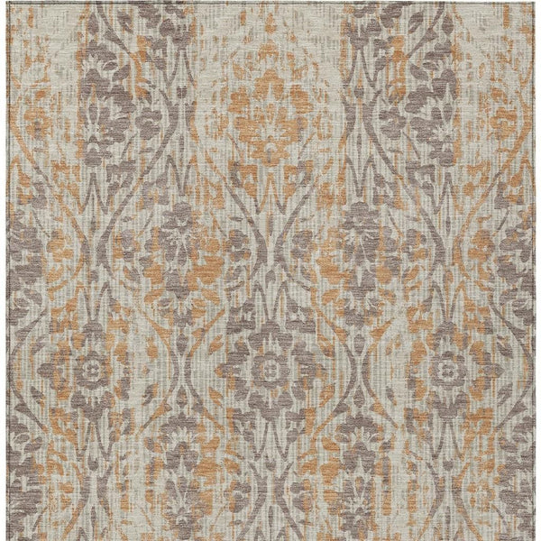 Beige area rug with gray and copper damask pattern, dense distressed motif.