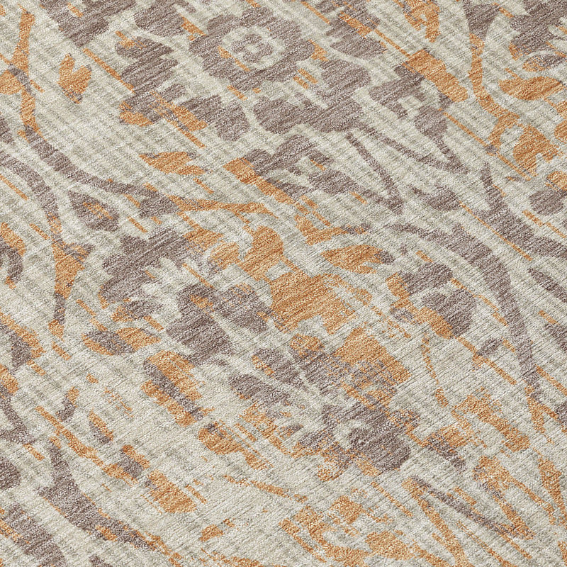 Close-up of beige rug texture with gray damask and copper accents, distressed weave.