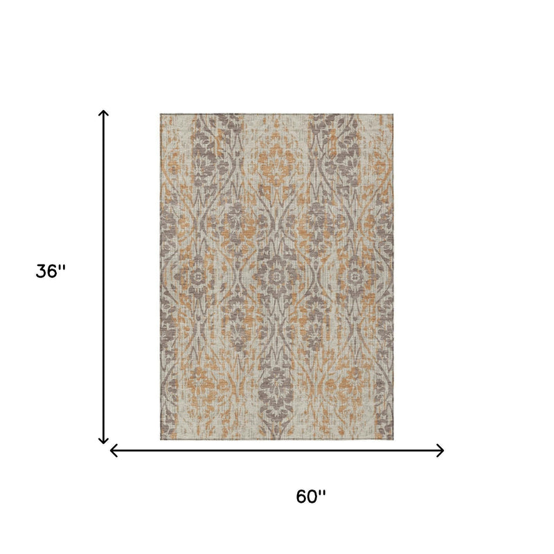 Damask area rug, beige with gray and copper tones; 60 in wide by 36 in long.