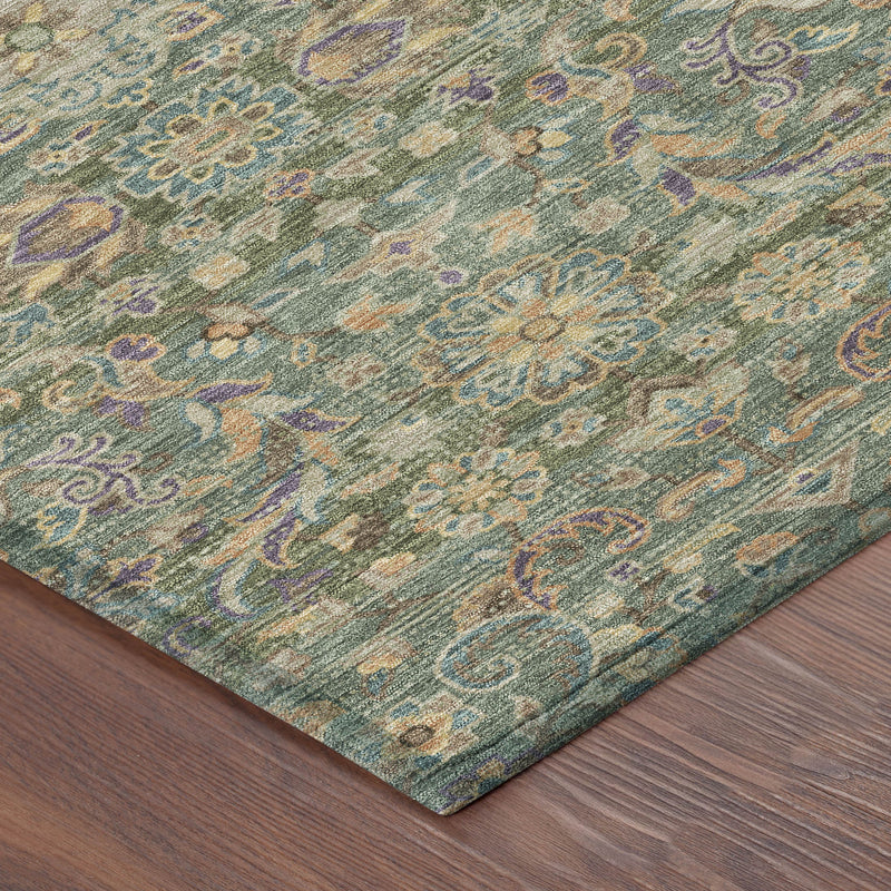 Indoor outdoor area rug corner, green and sage floral medallion pattern on textured weave.