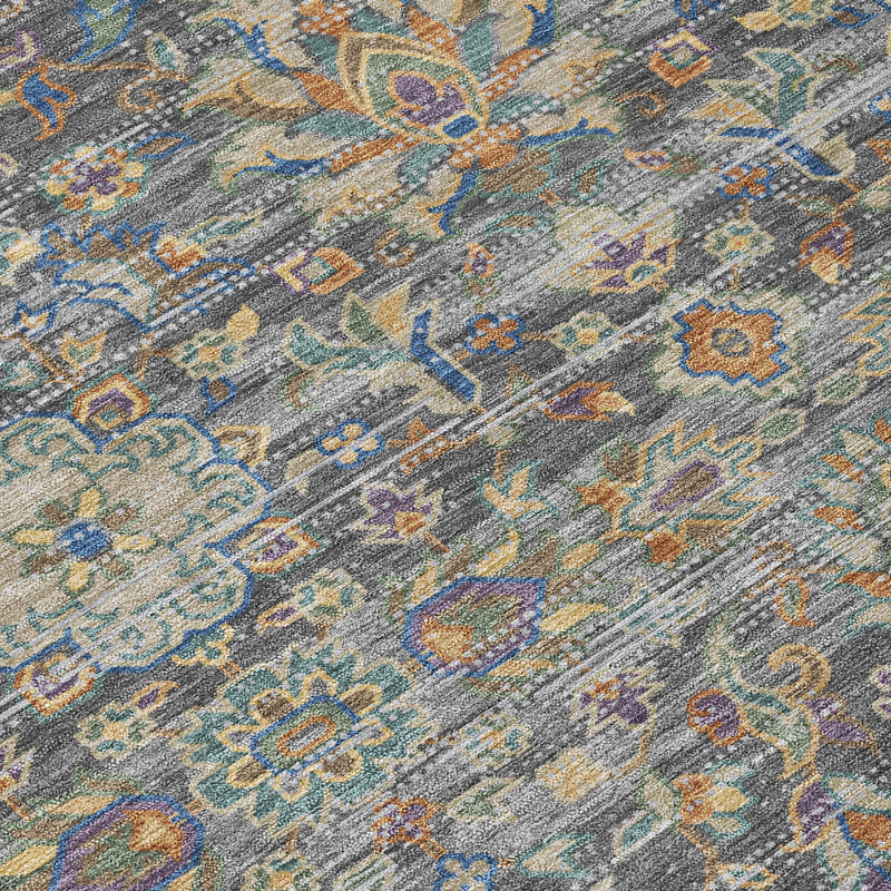 Gray and silver floral medallion area rug pattern detail with blue and gold accents.