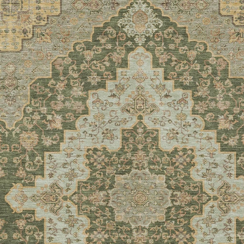 Detailed pattern view of green area rug with gold and beige medallion design